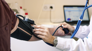 Healthcare worker taking blood pressure