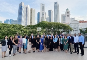 Attendees outside in front of a city skyline