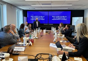 Colleagues around a conference table viewing a presentation