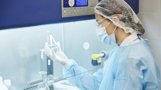 Female scientist in lab with beaker