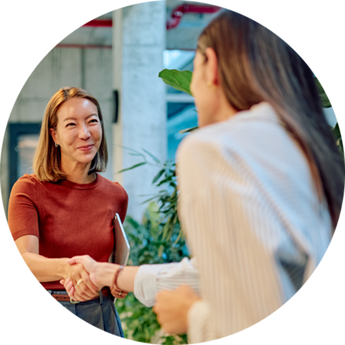 two women shaking hands
