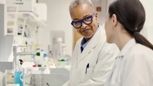 Person working in a lab wearing safety glasses