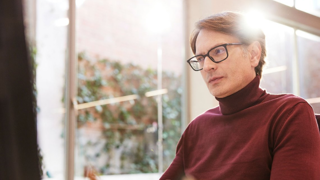 Individual wearing glasses and turtle neck