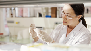 Woman in lab coat doing testing