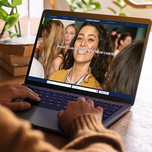 Campari’s website shown on a laptop screen with the image of a smiling woman 