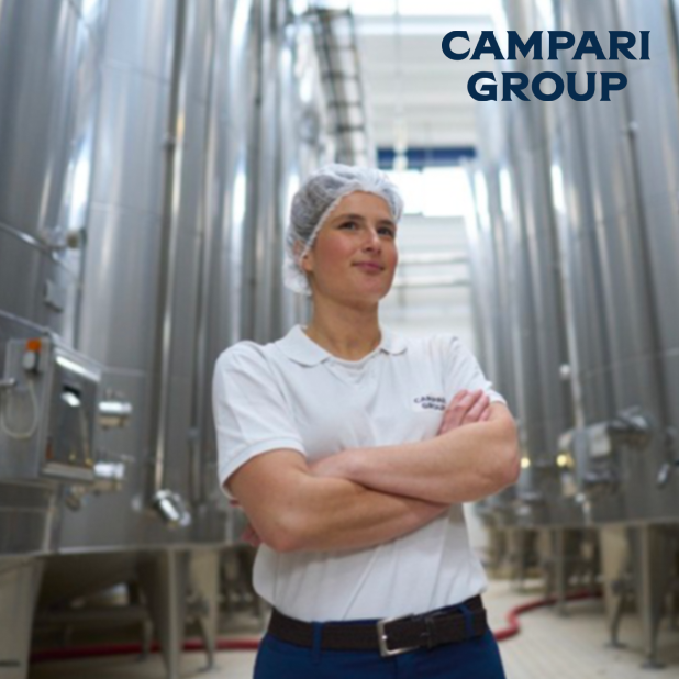 Person standing in factory with arms crossed