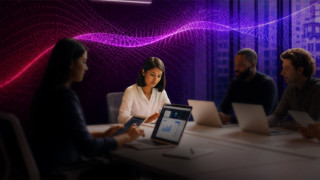Individuals with laptops and a vibrant glow behind them