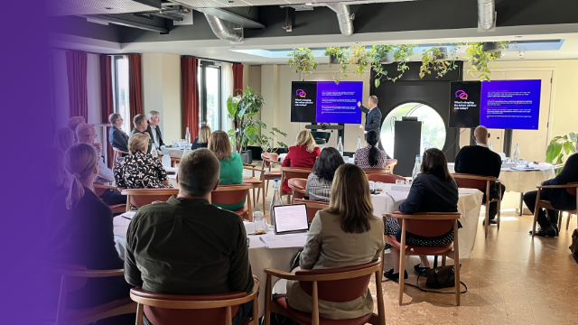 group of professionals sat in front of a presentation