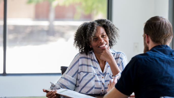 Two coworkers sitting and talking