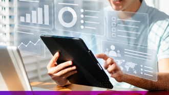 Person on tablet with graphics of modules and graphs appearing to come out of the tablet screen
