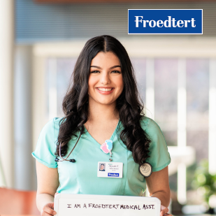 Smiling nurse holding a sign